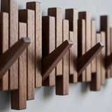 Recital Walnut Coat Rack — walnut grain and hooks close-up