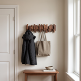 Recital Walnut Coat Rack — mounted in a hallway with coat and tote