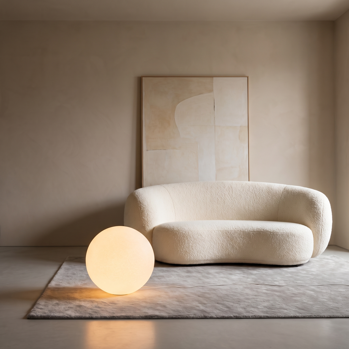 Luna Sphere Floor Lamp by a boucle chair under abstract wall art