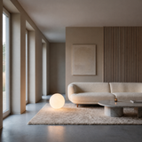 Luna Sphere Floor Lamp 40 cm beside a curved cream sofa in a minimalist living room