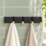 Foldable Hook Rack — Black/Gold, 4 hooks, towels on a green tiled wall