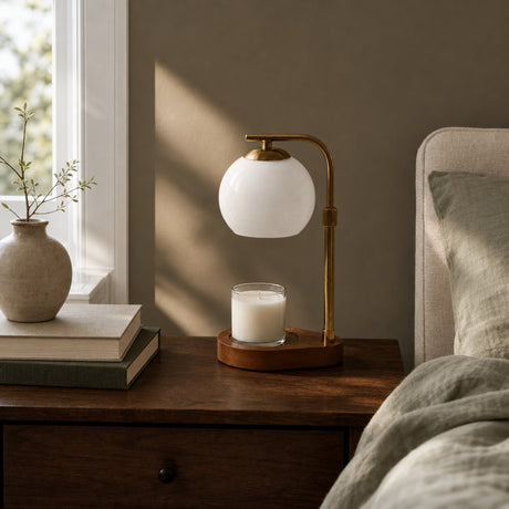 Lumen Candle Warmer Lamp in White on a walnut bedside table in daylight