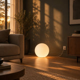 Luna Sphere Floor Lamp — living room at golden hour, lamp on