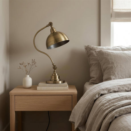 Antique Brass Gooseneck Desk Lamp - on an oak nightstand beside a linen bed