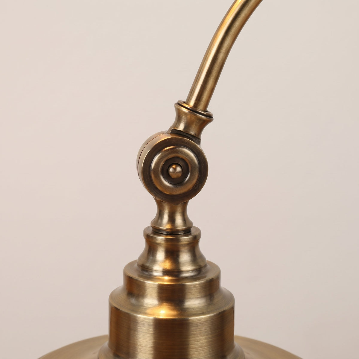 Antique Brass Gooseneck Desk Lamp - close-up of the brass swivel joint and stepped base