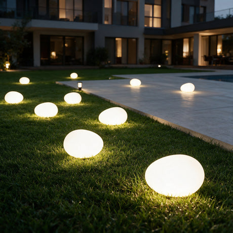 Pebble Glow Landscape Light - lifestyle image pool deck at dusk